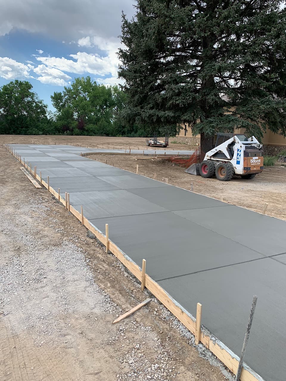 Freshly placed driveway section documented inside the formwork.